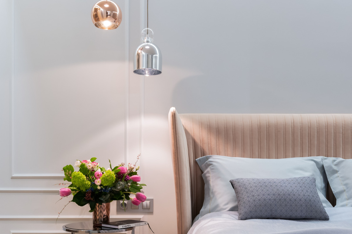 Como fazer a iluminação de apartamento? Dicas simples para valorizar seu ambiente! Cama no quarto com luminária ao lado. Imagem ilustrativa para texto iluminação de apartamento.